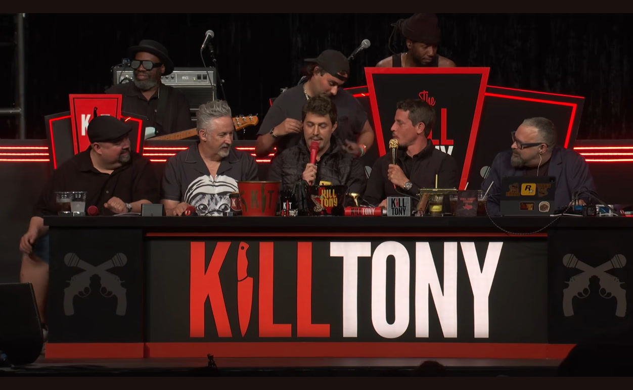 Adam Ray as Tony Hinchcliffe seated next to the real Tony Hinchcliffe on the Kill Tony panel, Intuit Dome, episode 780.